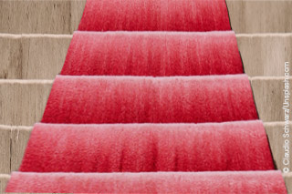 A red carpet on a staircase leading upwards